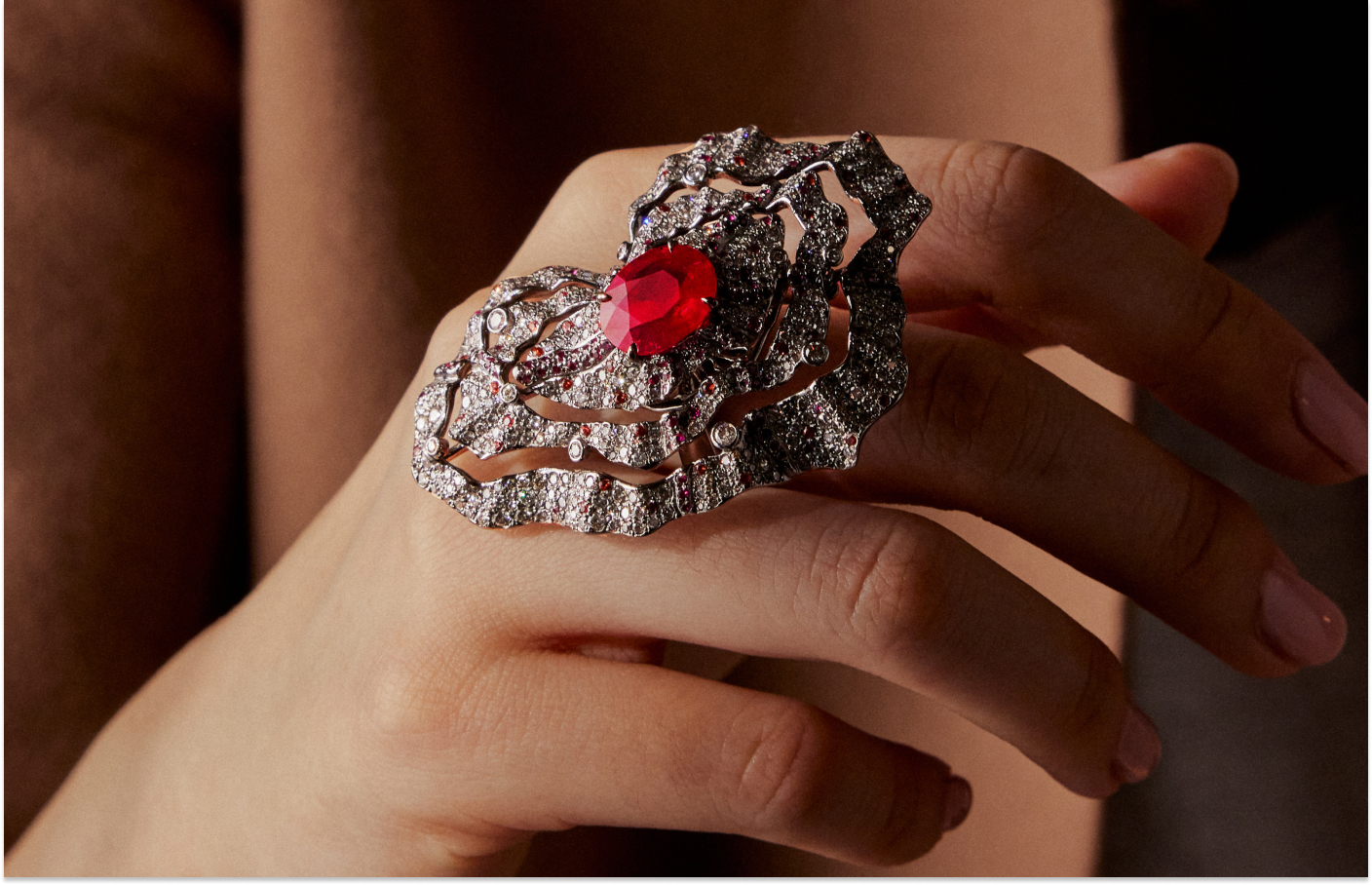 Faith Jewels Fire ring with a central 5.02-carat oval step-cut Burmese pigeon's blood untreated ruby, grey diamonds, white diamonds, rubies, and orange sapphires set in grey titanium