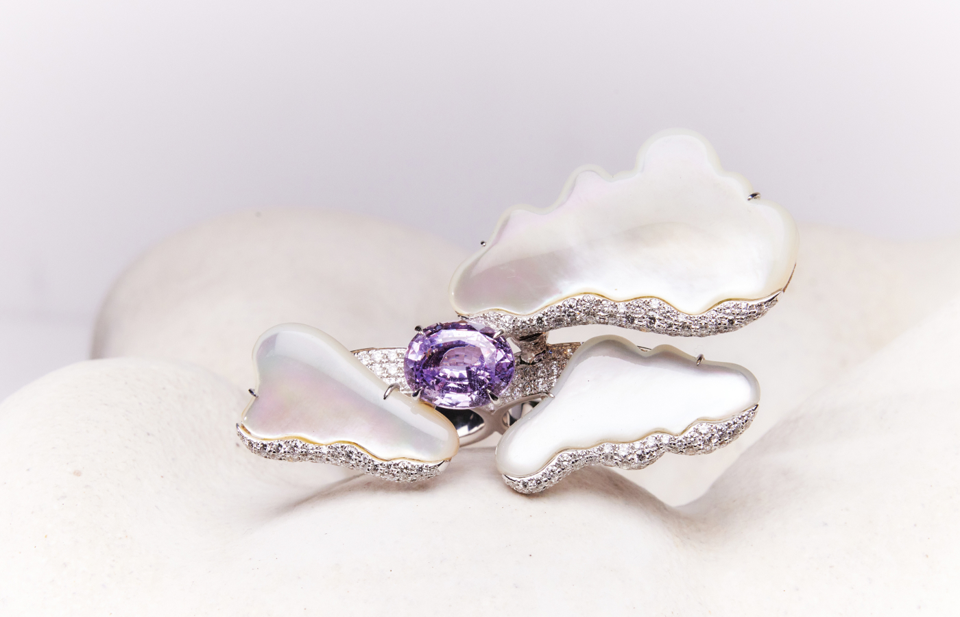 Faith Jewels Cloud Ring with a 6.88-carat oval-cut Madagascan sapphire, three freeform mother of pearl tablets, claw set on a mechanism providing two directions of movement. 294 round brilliant-cut natural diamonds for a total of 4.36-carats, all set in 18k white gold
