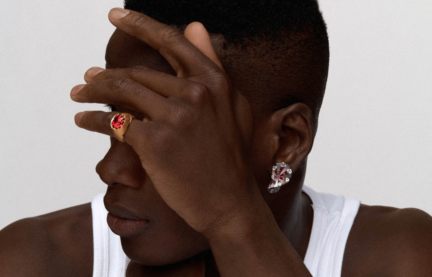  Model wearing REZA garnet and spinel ring and earrings