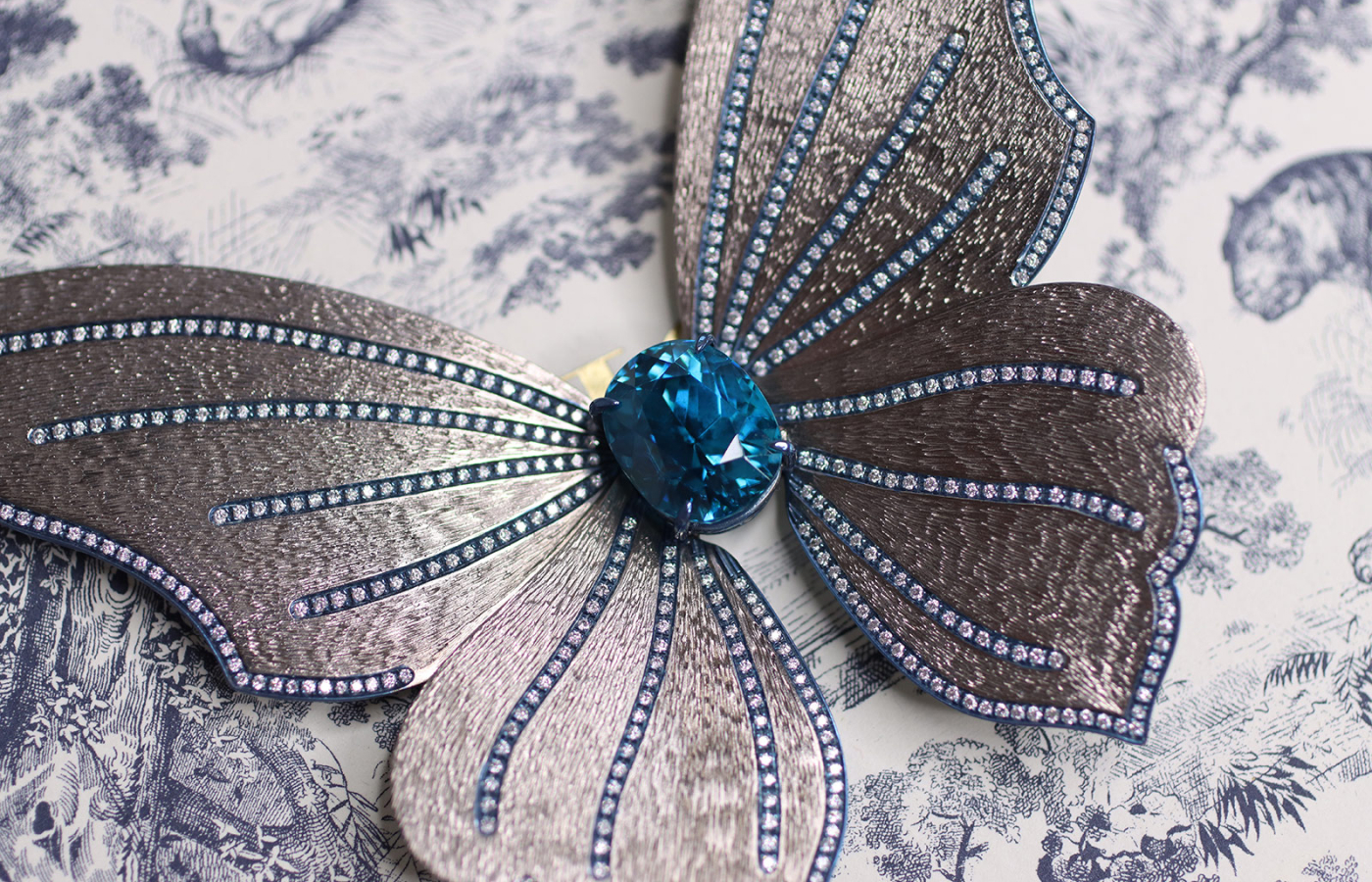 A closer look at Katerina Perez's butterfly earring with a blue zircon and diamonds set in titanium