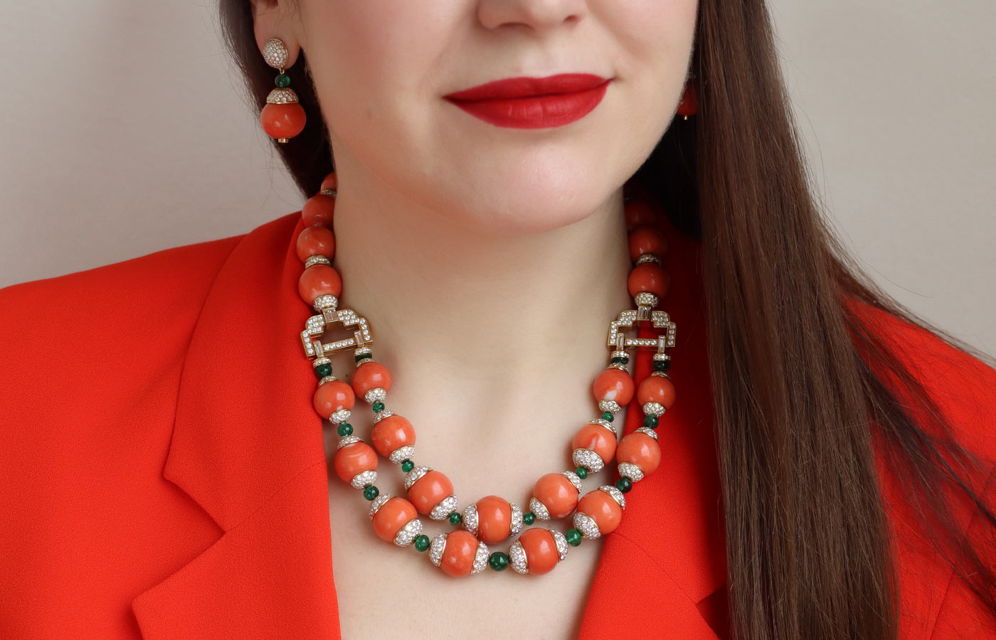  Katerina Perez wears a Veschetti necklace with coral beads, emerald beads and diamonds in gold 