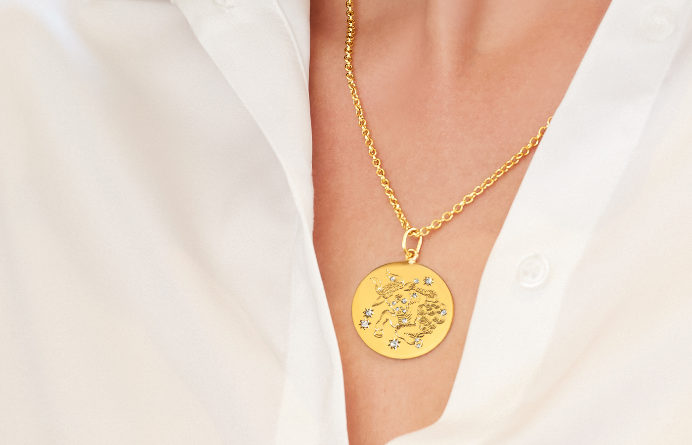 Model wearing Verdura Taurus Zodiac necklace in gold and diamond