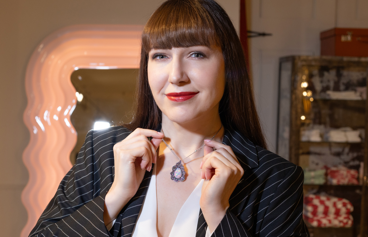 Katerina Perez wears a one-of-a-kind pear-shaped opal, multi-coloured sapphire and diamond necklace by ZARIG