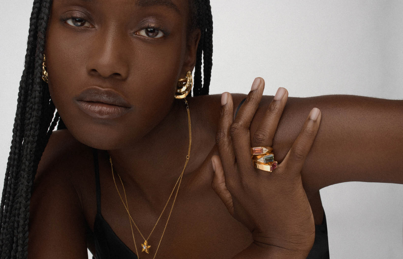  Model wearing REZA jewellery in gold and sapphire
