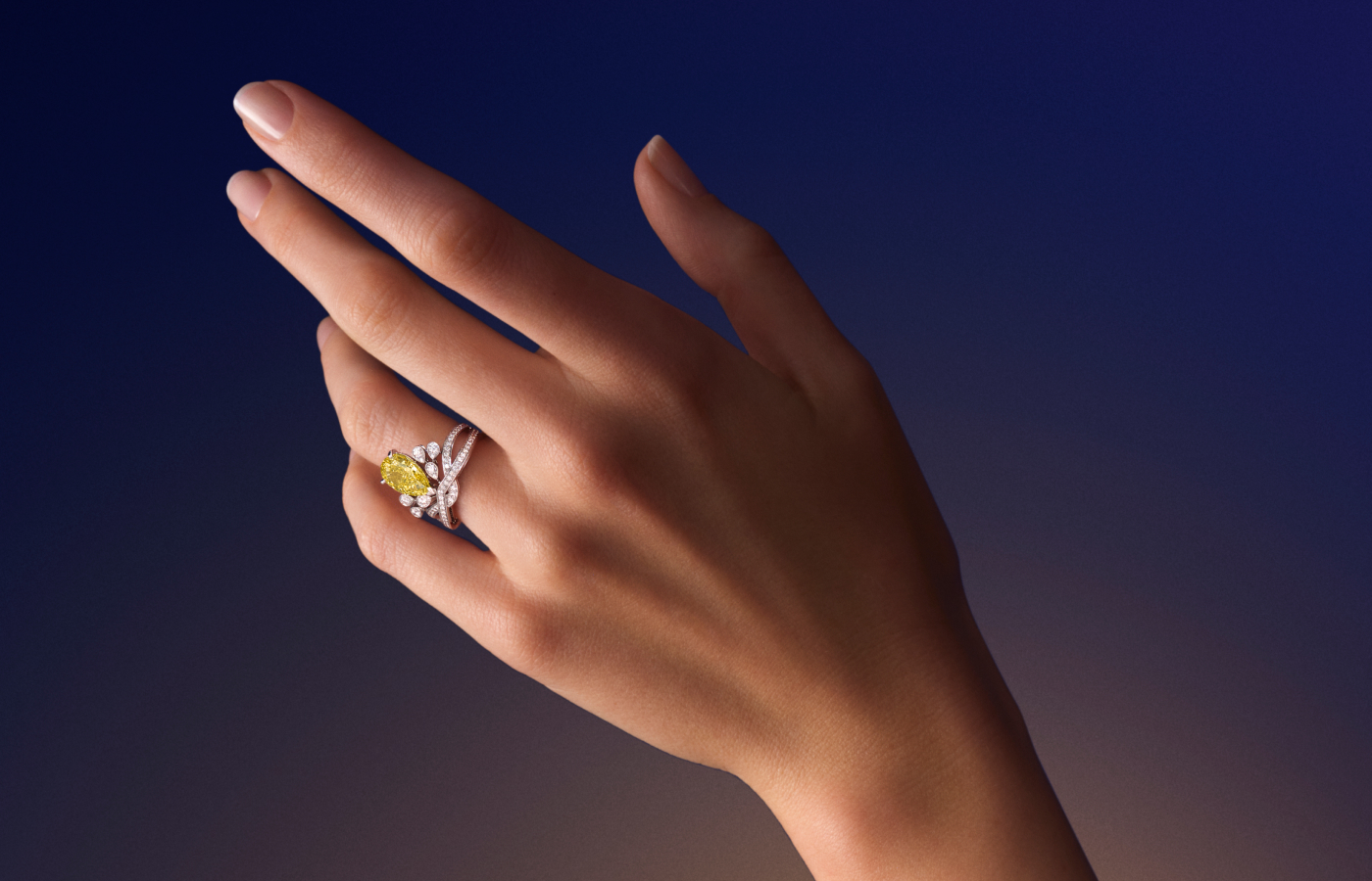 Model wearing Chaumet Josephine ring in white gold and diamond, featuring a pear-cut yellow diamond from the Josephine collection