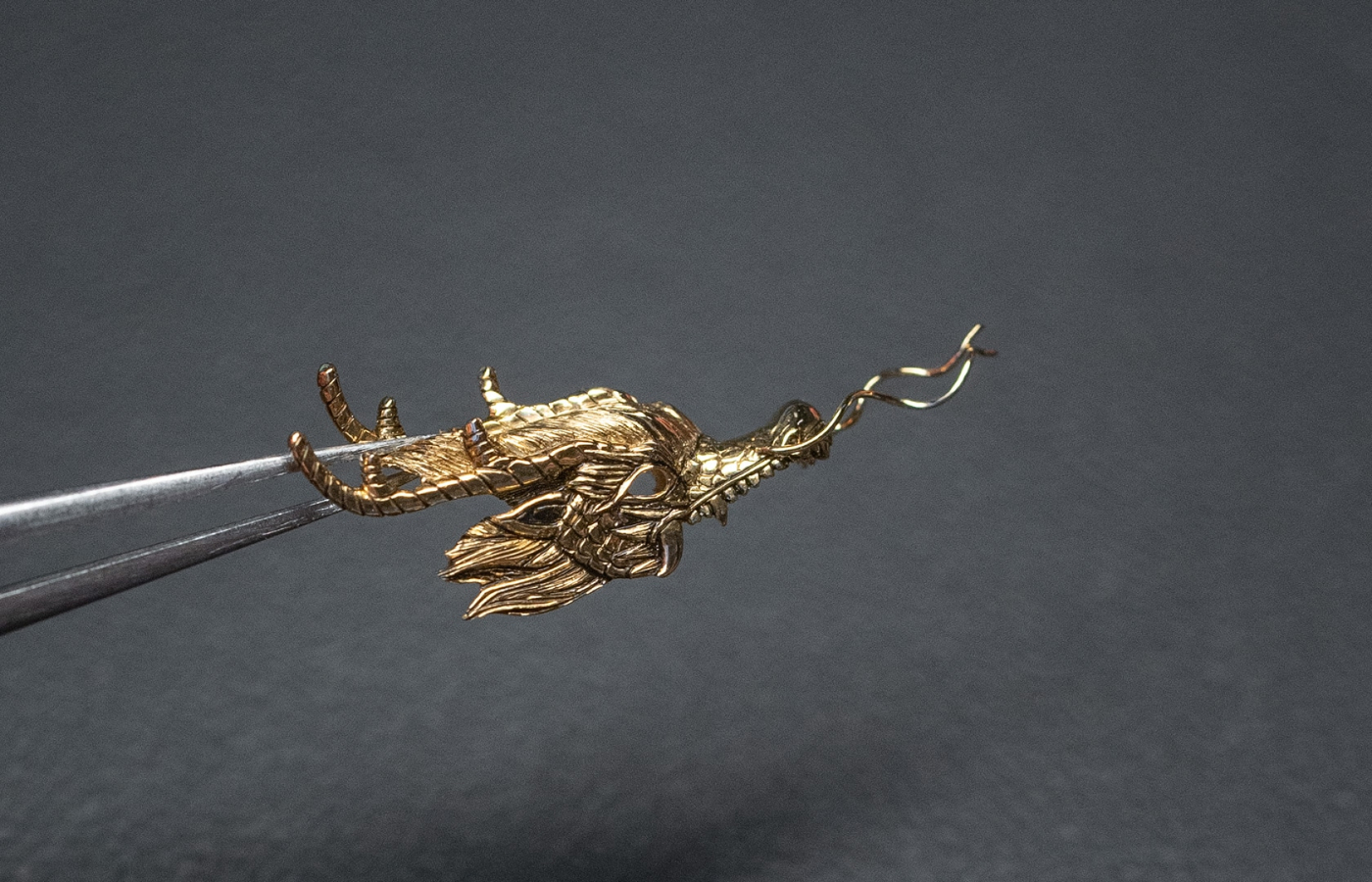  The dragon features  all the distinguishing Chinese dragon traits, including two moustache tendrils pointing upwards, a full beard and gently rounded teeth