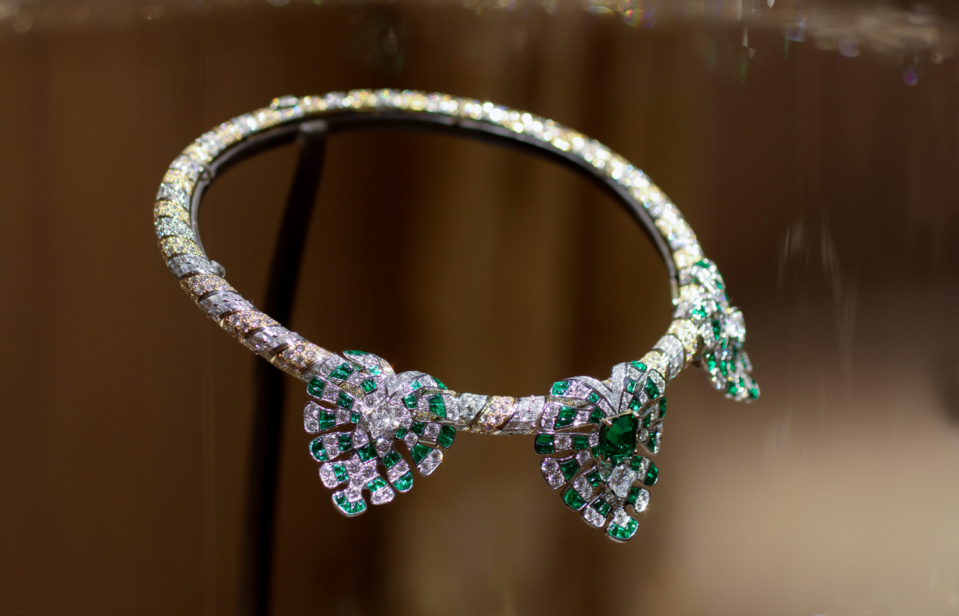 A photograph of the Plants necklace with 302 custom-cut diamonds and 132 custom-cut Zambian emeralds with a rare blue hue, from the Louis Vuitton Deep Time Chapter II High Jewellery collection