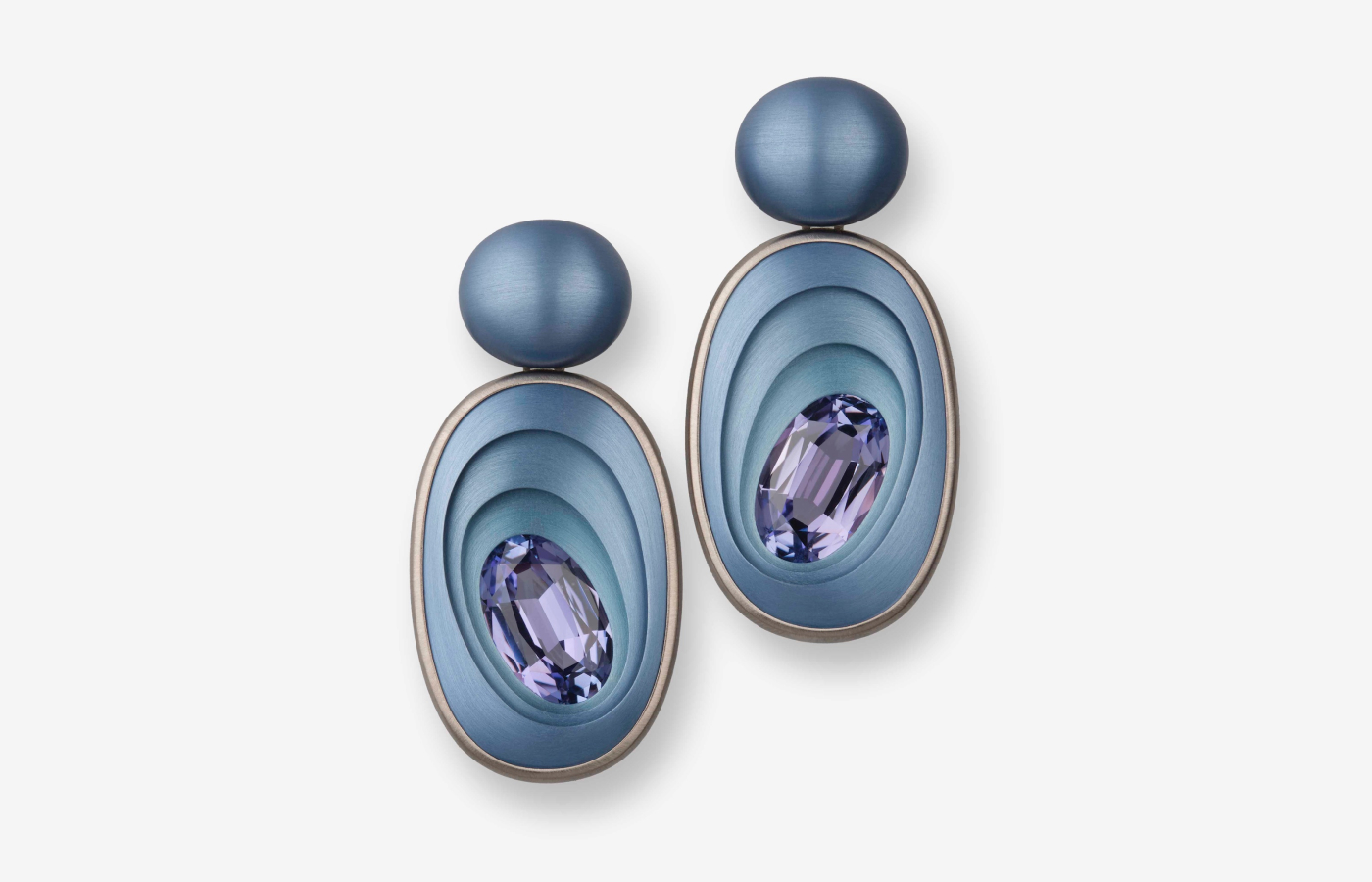 Hemmerle earrings with oval-shaped tanzanites set in aluminium and white gold. Courtesy of Hemmerle