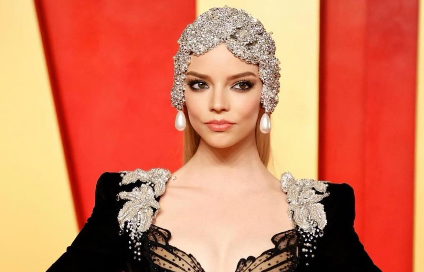 Anya Taylor-Joy attends the Vanity Fair Oscars Party 2024 wearing a Miss Sohee dress, a bejewelled headpiece with pearl drops, a Tiffany & Co. archival bracelet with diamonds (1920-1930), and a matching ring with 5 carats of diamonds 