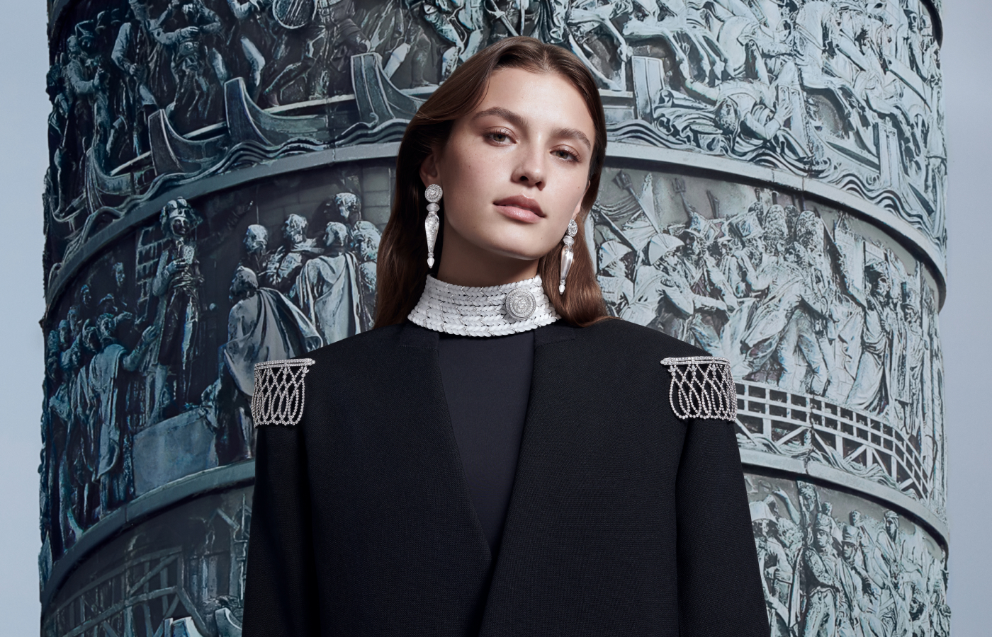 A model wears the Boucheron Aiguillette pendant earrings, the Tricot necklace set, and the Epaulettes shoulder brooch all with diamonds and rock crystal in 18k white gold from the Histoire de Style The Power of Couture High Jewellery Collection