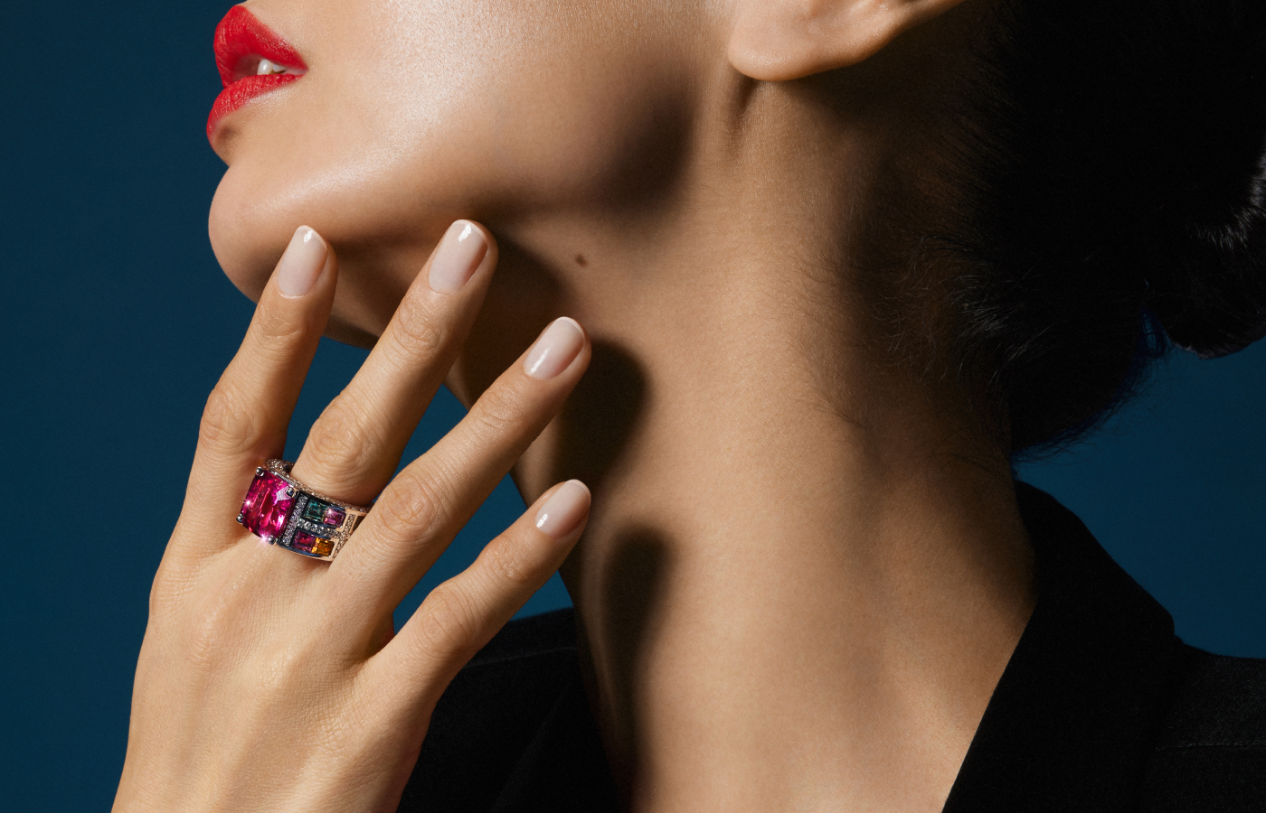 A model wears a Bucherer Fine Jewellery ring with an 8.13-carat octagonal rubellite, pink tourmalines, orange sapphires, baguette-cut green sapphires, pink rubellites and 152 brilliant-cut diamonds from the Manhattan High Jewellery collection 