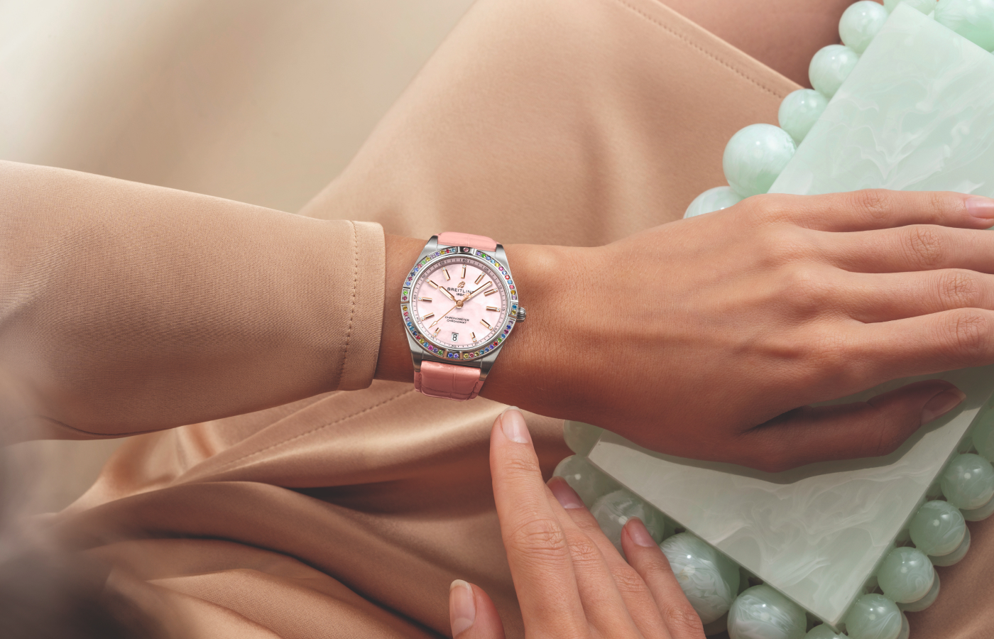 Model wearing Breitling Chronomat Automatic 36 South Sea watch in stainless steel, white gold, mother-of-pearl, multicoloured gemstones and diamond