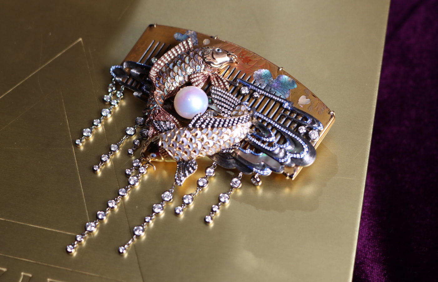  A closer look at the Austy Lee ‘The Solar & Lunar’ brooch from The Ancient Fetus collection in 18k yellow and rose gold with antique Japanese lacquerware, South Sea pearl, mother-of-pearl, abalone shell and white diamonds