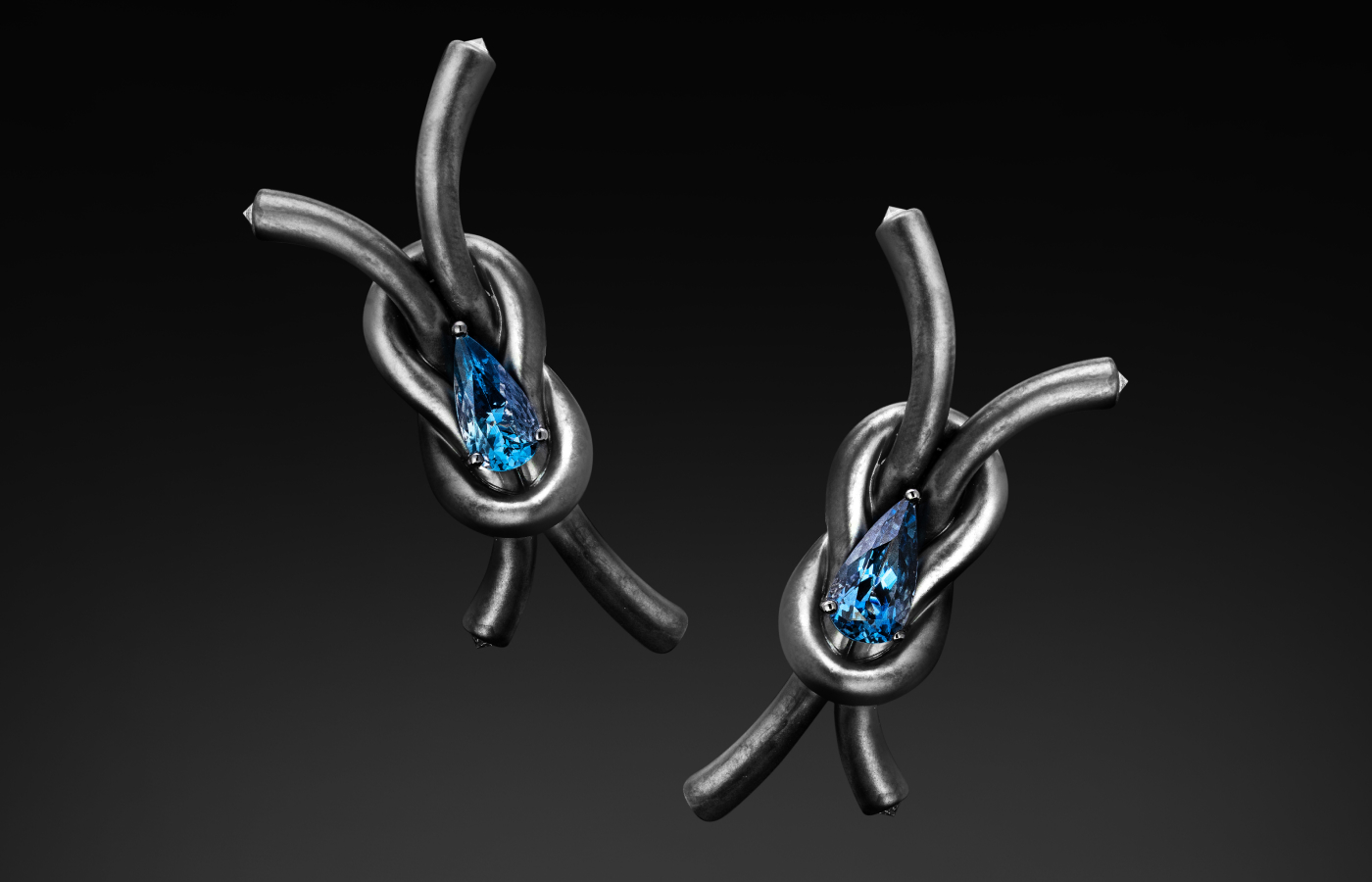Austy Lee ‘The Silver Reef Knot’ earrings from The Lock-Knot collection in 18k white gold with Santa Maria deep blue aquamarine and white diamonds