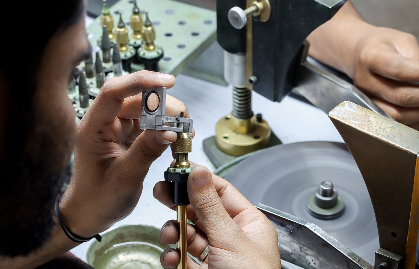  A Minehaus employee calibrating and measuring a gemstone to ensure it has  perfect proportions 