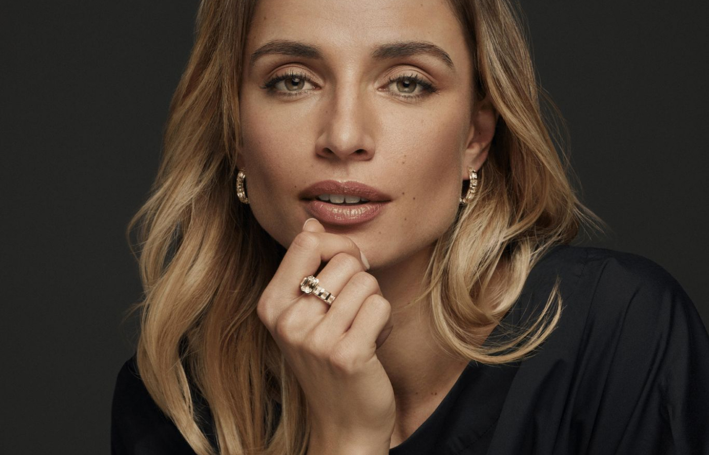 A model wears a Schaffrath Paradoxal ring in 18k yellow gold with a 3.23 carat emerald-cut diamond, 5.45 carats of emerald-cut diamonds and 3.36 carats of round brilliant-cut diamonds, plus Paradoxal Creole earrings with 3.40 carats of Asscher-cut fancy yellow diamonds and round brilliant-cut white diamonds