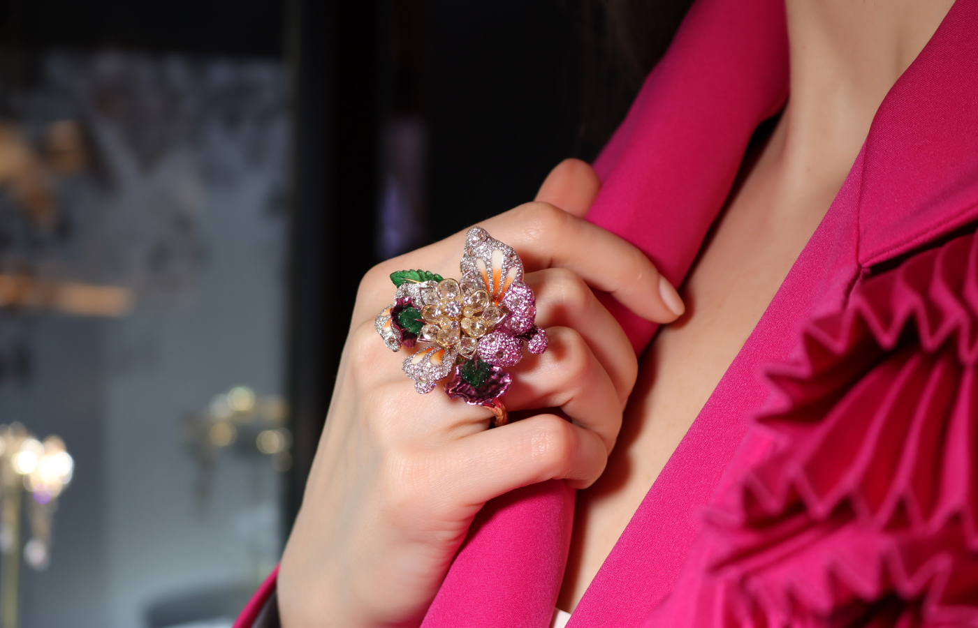 Katerina Perez wears the Diva Jewels Magical Blossom ring from the Marvels of Nature collection with yellow and white rose-cut diamonds, further diamonds, carved emeralds, rhodium plating and enamel on 18k yellow gold 