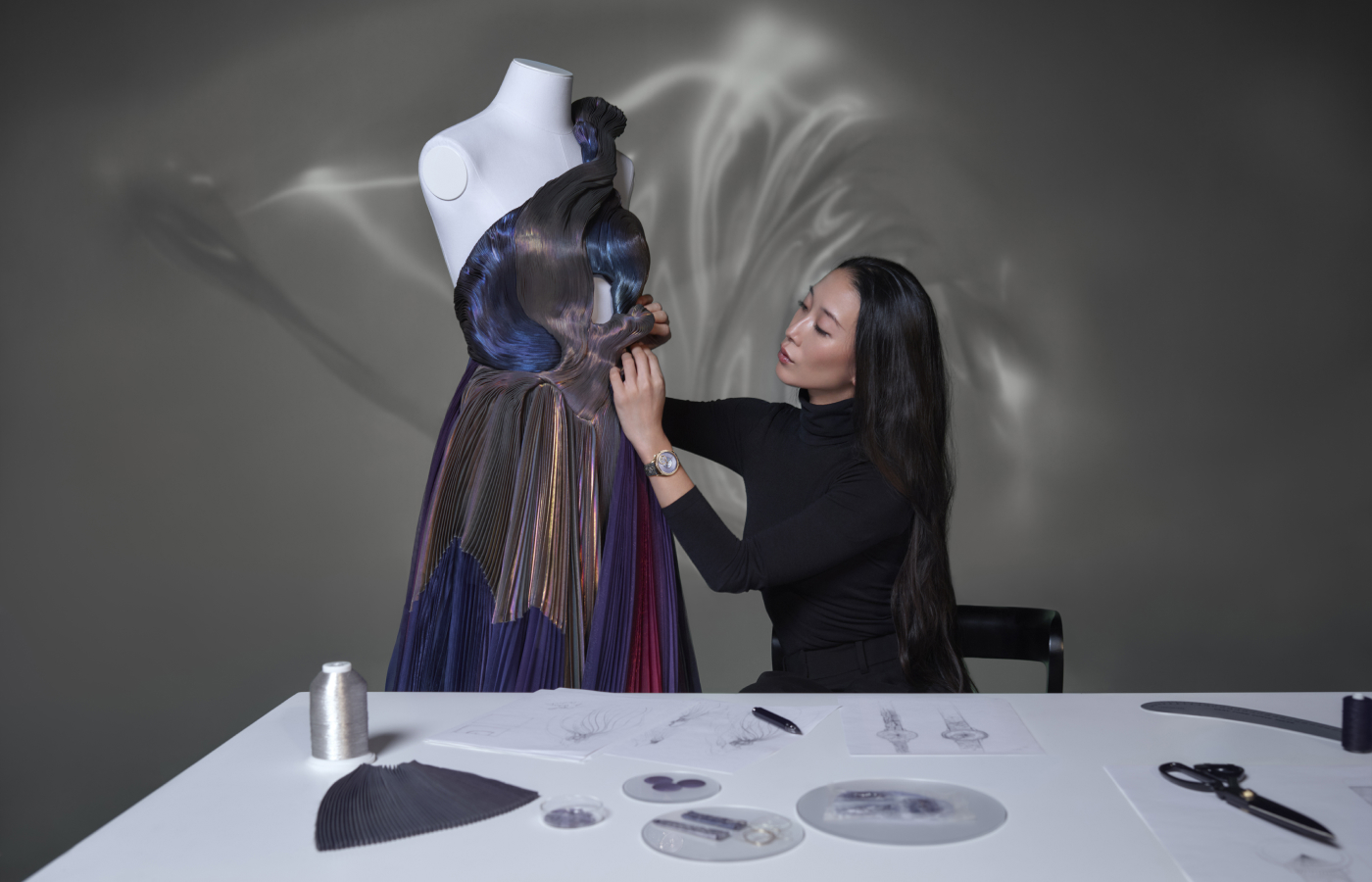  Designer Yiqing Yin working on the gown which she created alongside the invention of the Égérie - The Pleats of Time Moonphase 