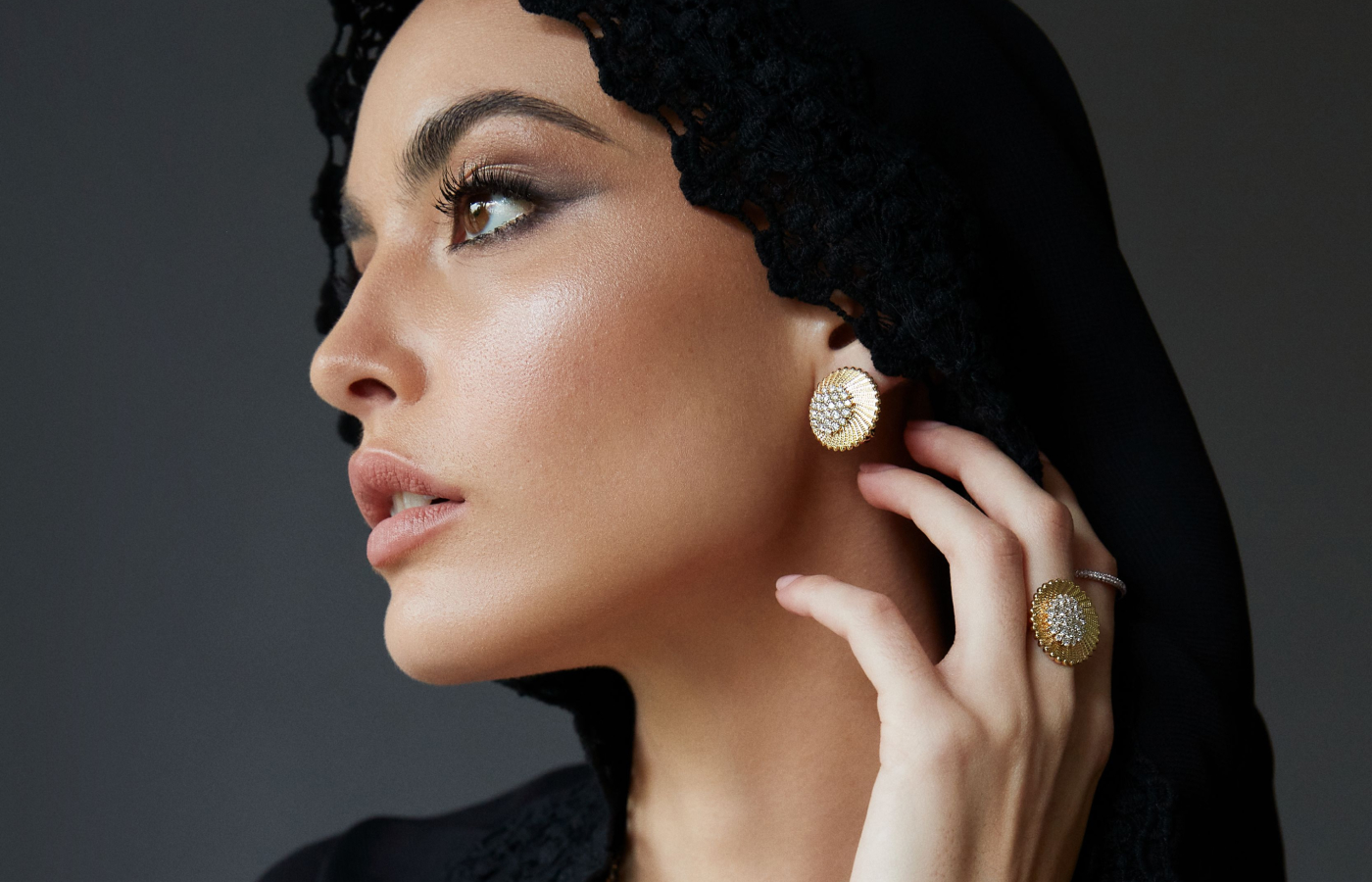 Model wearing Marceline Paris Maia earrings and ring from the Seven Sisters collection in gold and diamond