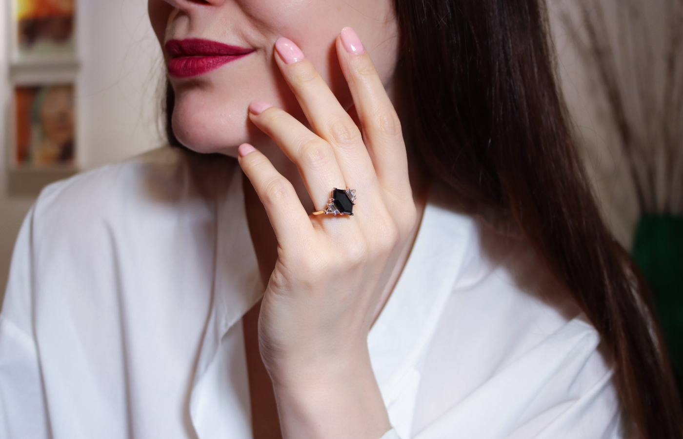 Katerina Perez wearing Anna Sheffield Theda Hex ring in gold set with a 4.56-ct black diamond and baguette and trillion-cut white diamond, along with various Nesting Bands made with reclaimed white diamond