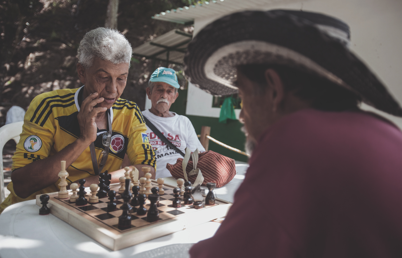 Local community members of the Boyacá region, where Muzo has its mine, playing chess