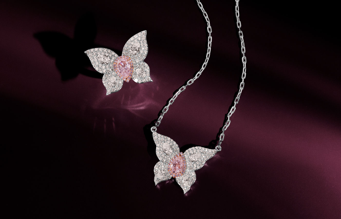 Le Vian Couture® ring with a one carat faint pink diamond centre stone, surrounded by 2.33 carats of Vanilla Diamonds® and further light pink diamonds set in platinum and 18K Strawberry Gold®, pictured alongside a matching pendant 