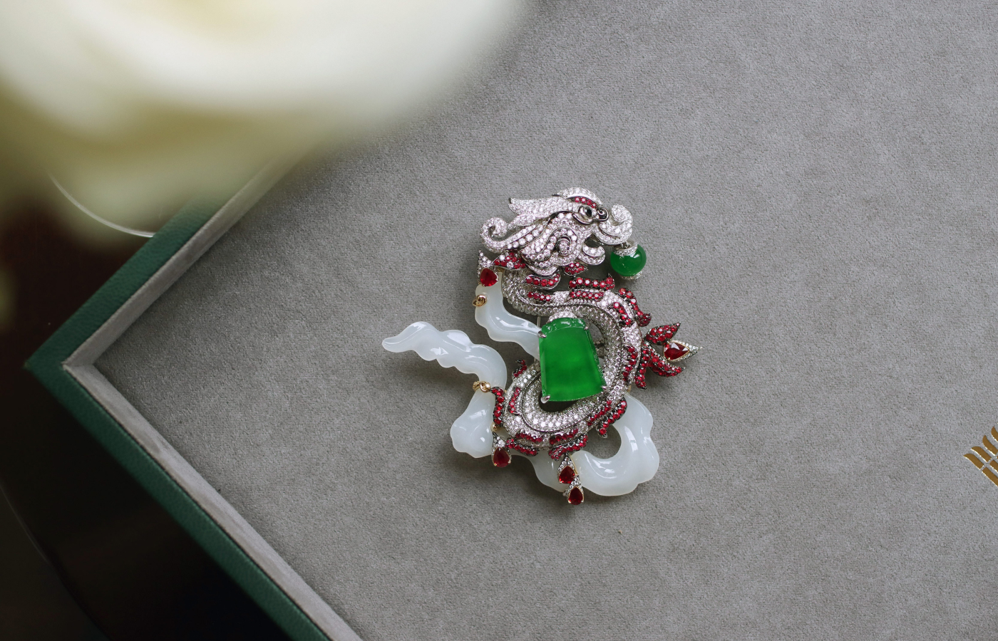  A closer look at the HEHE High Jewelry Dragon Ascension brooch from the Ascending Dragon High Jewellery collection in white jade, rubies and diamonds with a shield-shaped green jadeite and jadeite bead