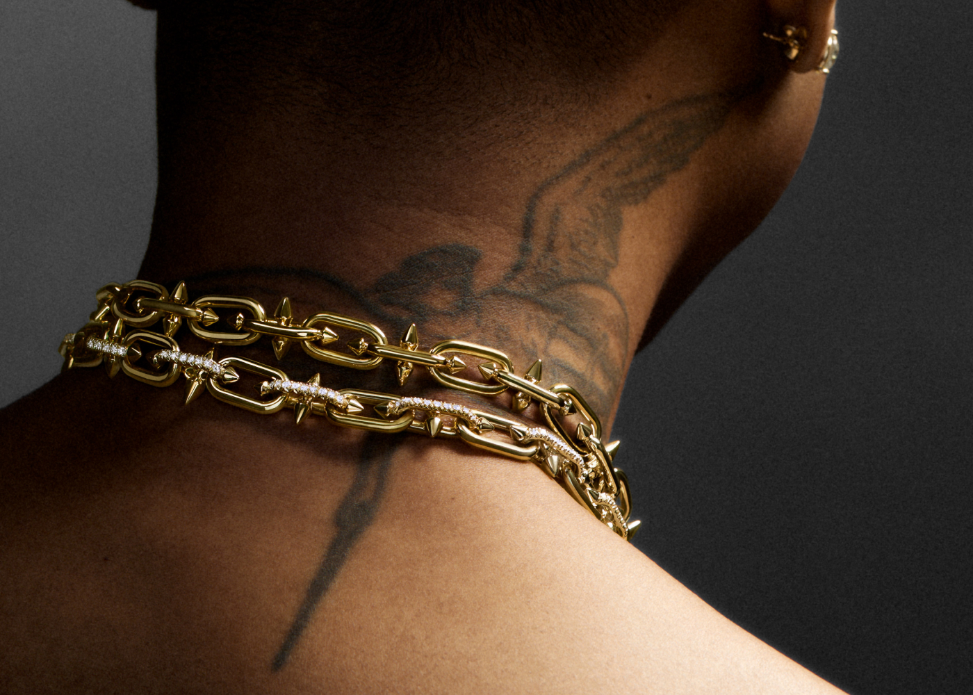  Pharrel Williams wearing Tiffany Titan by Pharrell Williams Clasp necklaces in gold and diamond