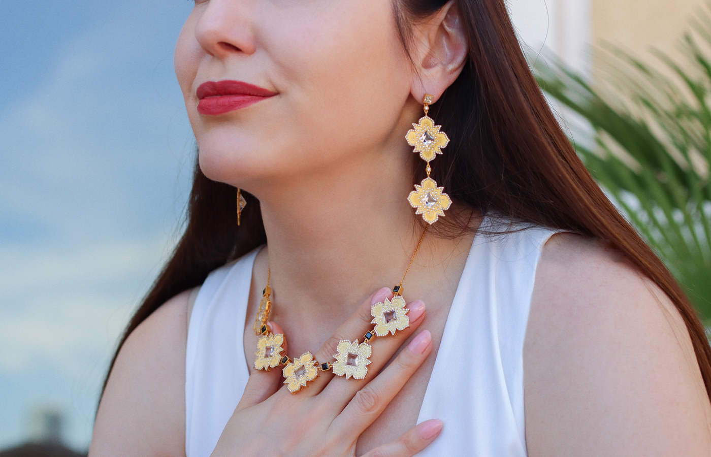 Katerina Perez wears the COOMI Trinetra earrings with 9.76 carats of rock crystal and 2.89 carats of diamonds and the matching Trinetra necklace with 4.22 carats of diamonds, 2.92 carats of black spinel and 9.99 carats of rock crystal, both set in 20k yellow gold 