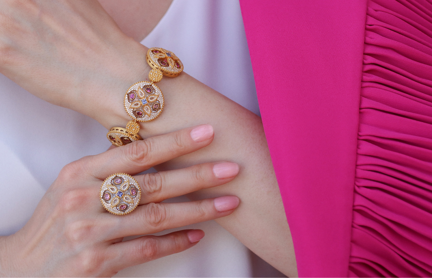  Katerina Perez wears the COOMI Trinetra ring with 1.73 carats of diamonds, 17.92 carats of crystal, pink tourmalines and tanzanites alongside the matching Trinetra bracelet with 7.22 carats of diamonds, 88.04 carats of rock crystal, 3.2 carats of pink tourmaline and tanzanite, both set in 20k yellow gold  