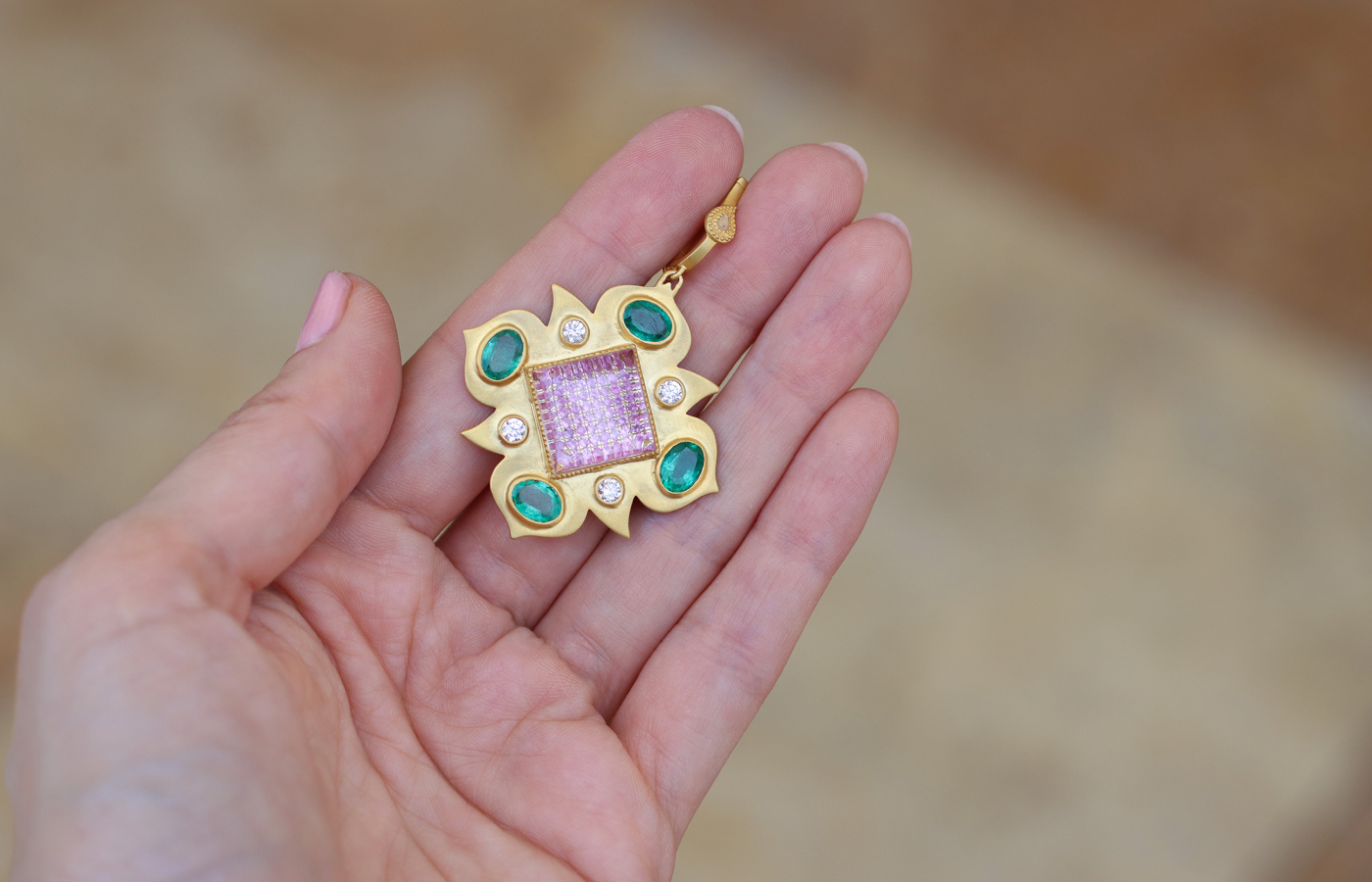 COOMI Trinetra pendant with 10.23 carats of rock crystal, 2.93 carats of emeralds, pink sapphires and diamonds, set in 20k yellow gold 