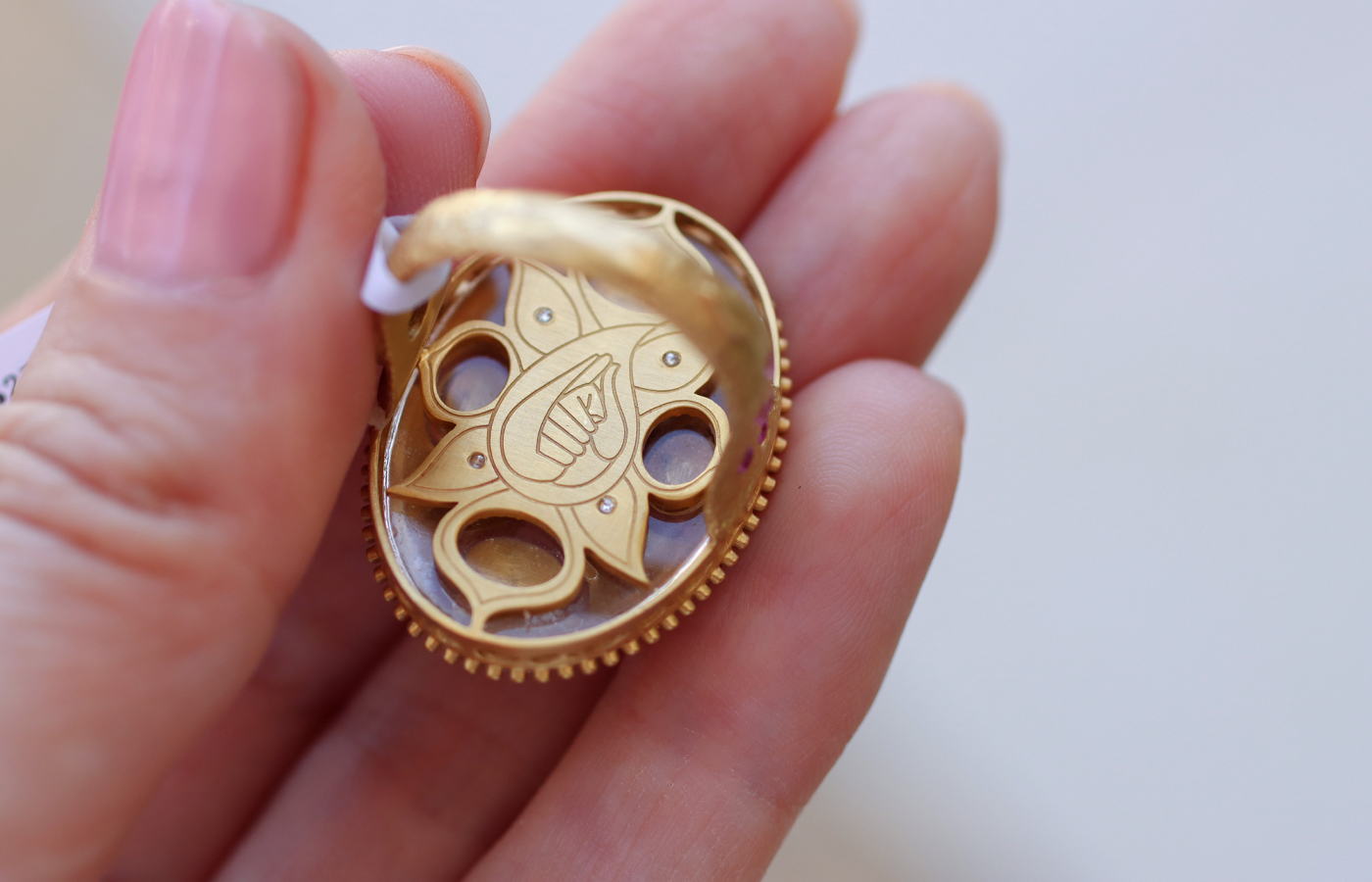  The engraved details on the reverse of a COOMI ring in the new Trinetra collection, crafted in 20k yellow gold, diamonds and rock crystal 