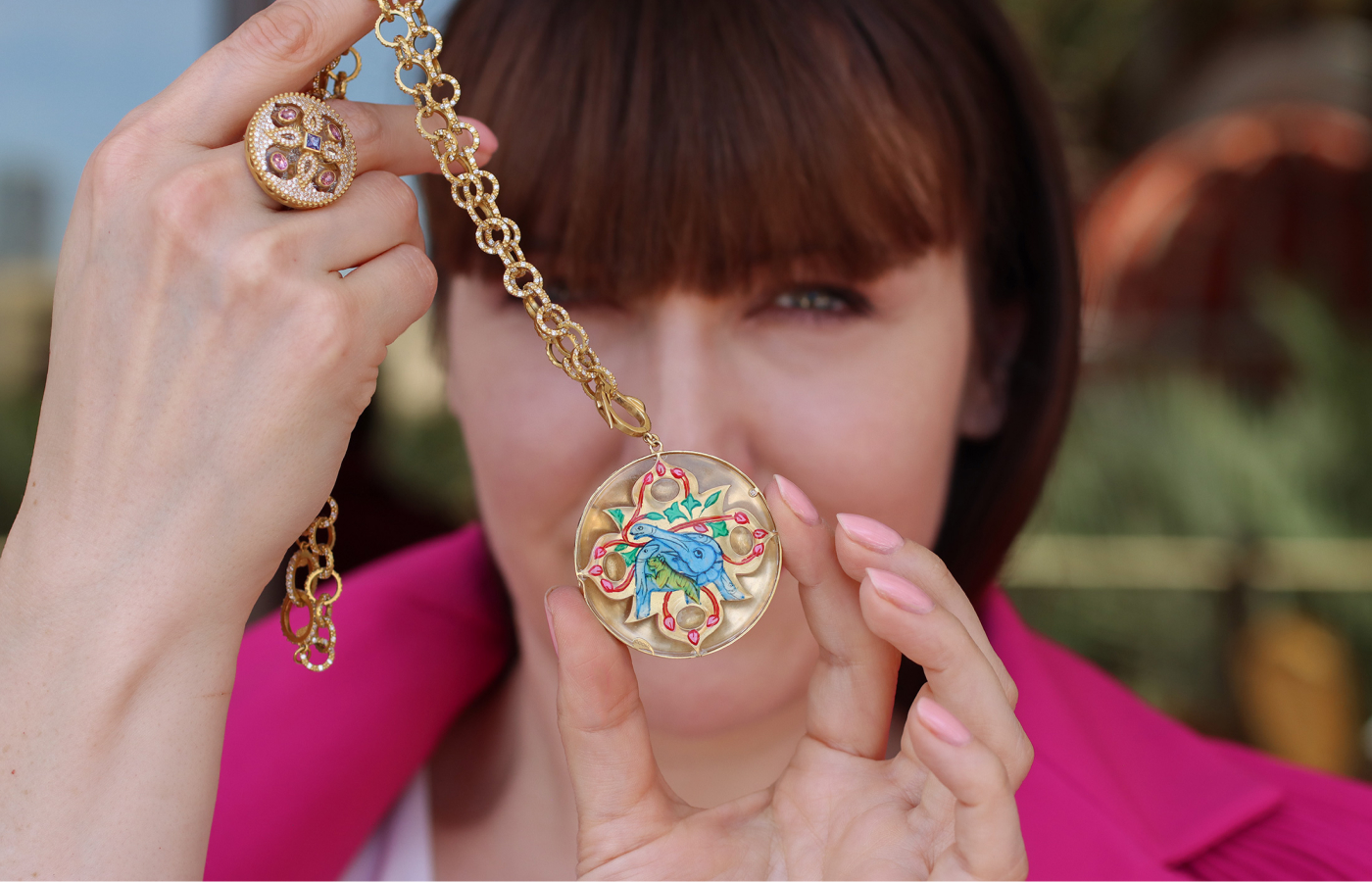  Katerina Perez showcases the elephant and tiger painting on the reverse of the COOMI Trinetra pendant with 5.34 carats of diamonds, 1.78 carats of tanzanite, 2.03 carats of tourmaline and 67.32 carats of rock crystal, set in 20k yellow gold 