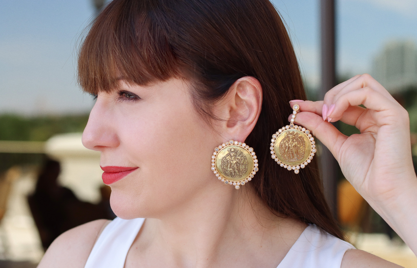  Katerina Perez wears COOMI earrings in 20k yellow gold with 5.51 carats of diamonds and antique gold Kushan coins, which can also be worn as studs 
