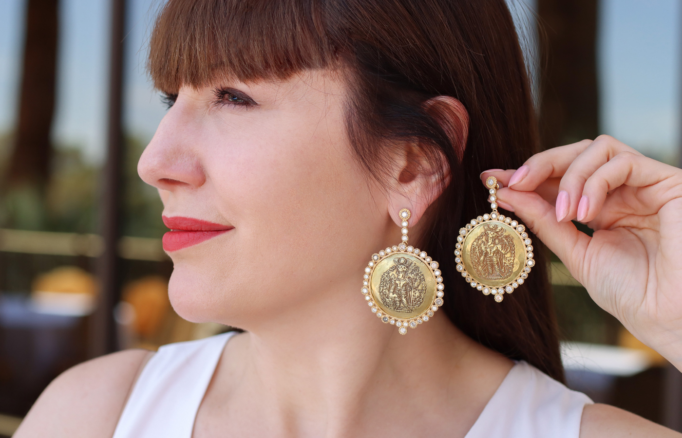 Katerina Perez wears COOMI earrings in 20k yellow gold with 5.51 carats of diamonds and antique gold Kushan coins