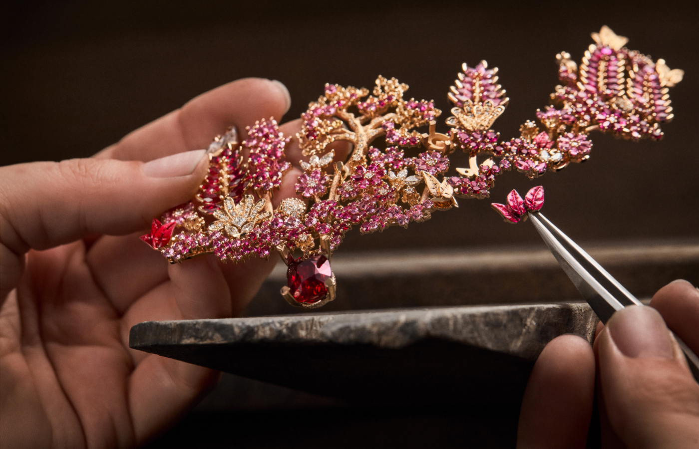  Adding red lacquered leaves to a woodland-inspired Dior Joaillerie necklace set with rubies, sapphires, cultured pearls, and diamonds in the Diorama & Diorigami High Jewellery collection