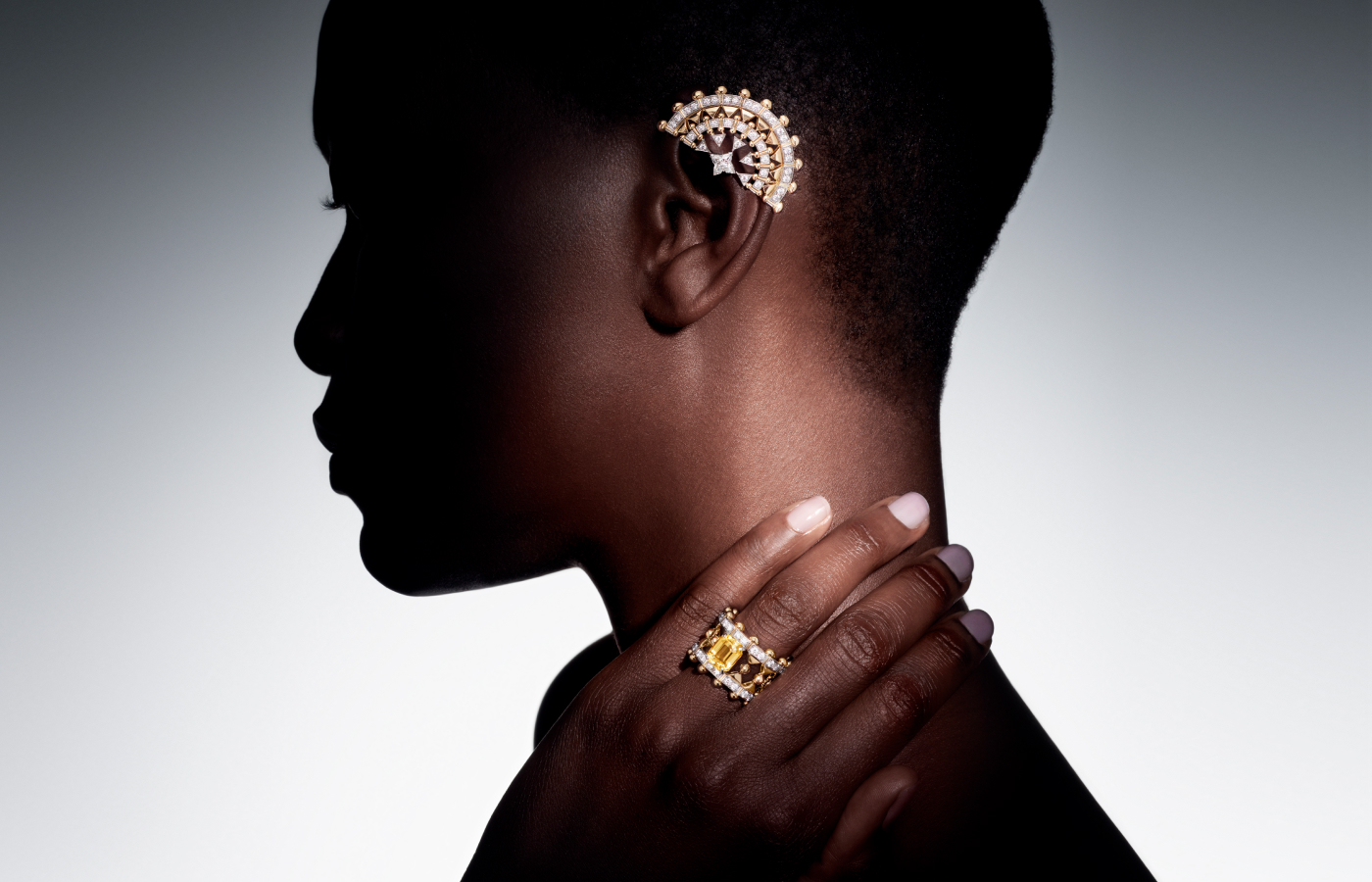  Model wearing Louis Vuitton Vision earrings and ring with two octogonal step-cut yellow sapphires of 7.45 and 6.50 - carats, one 3.80 - carat octogonal step-cut yellow sapphire, two LV Monogram Star cut diamonds of 0.73 - carat, yellow sapphires and diamonds in gold and platinum from the Awakened Hands, Awakened Minds collection