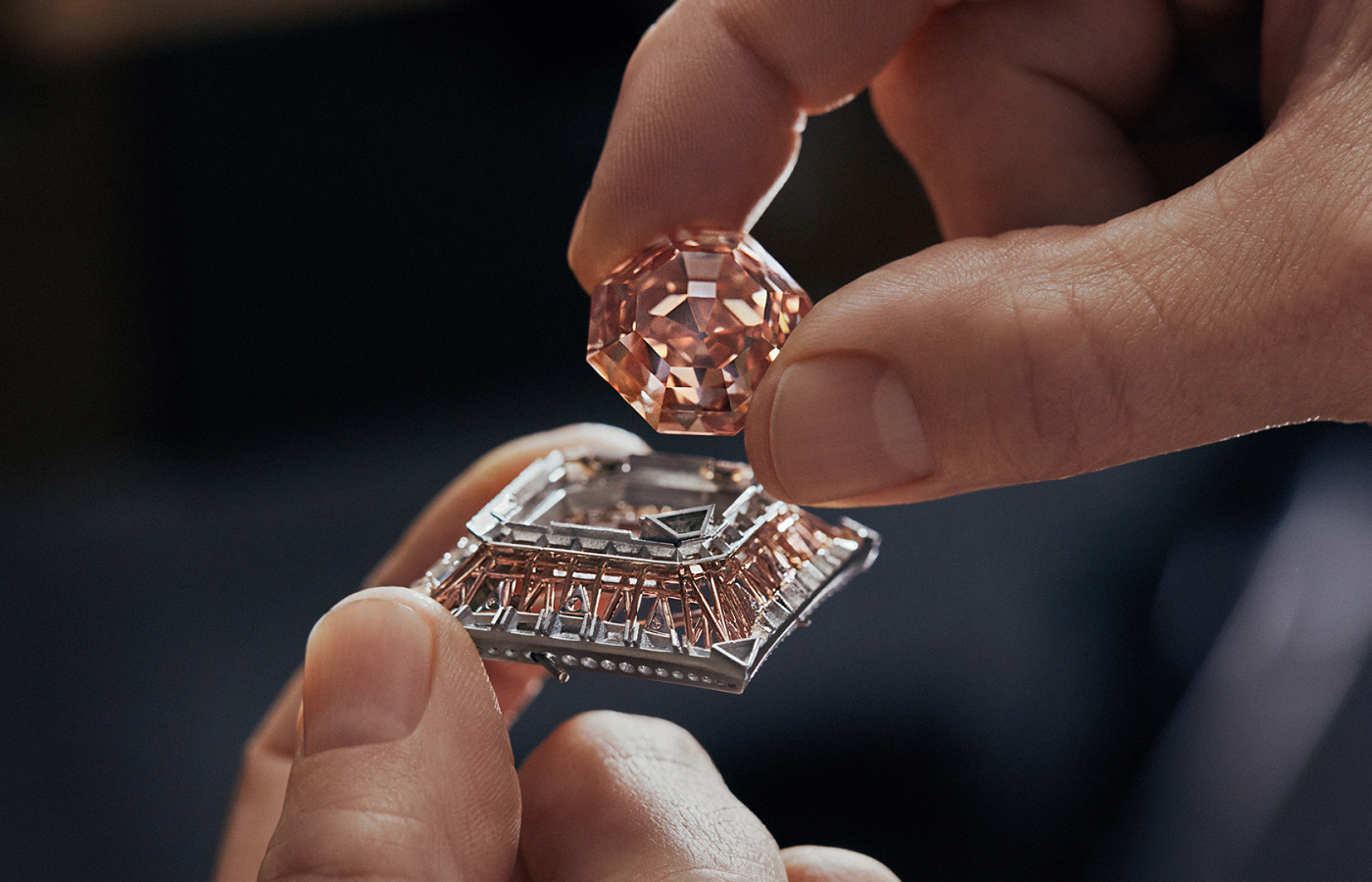  The Louis Vuitton Cœur De Paris necklace from the Awakened Hands, Awakened Minds collection is set with a 56.23 - carat fancy deep orangy-pink square emerald-cut diamond