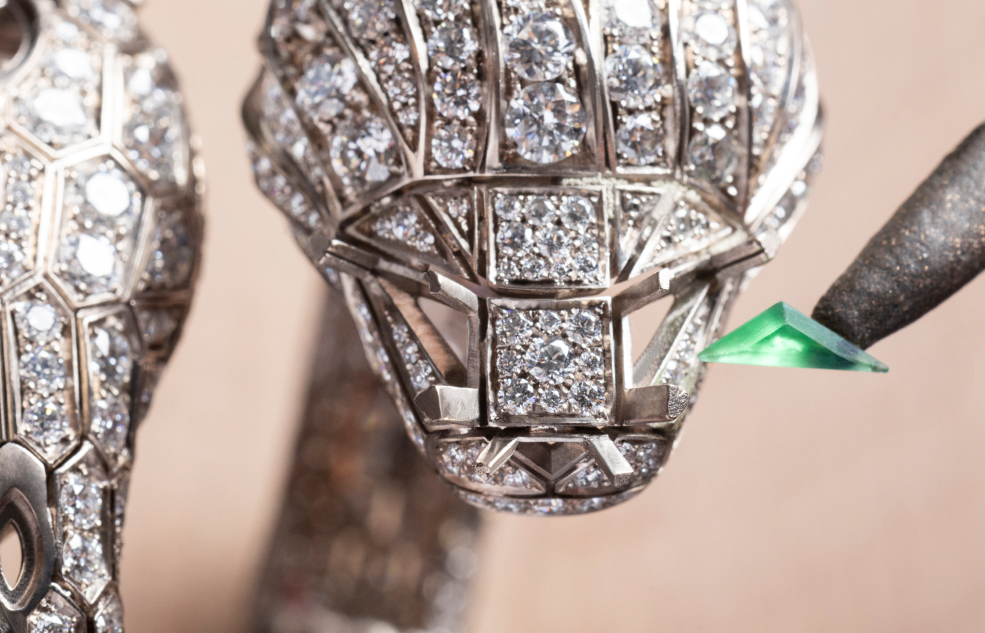  An emerald being set onto the Bvlgari Serpenti Misteriosi Chimera secret watch from the Aeterna collection with emeralds, diamonds and sapphire in 18k white gold 