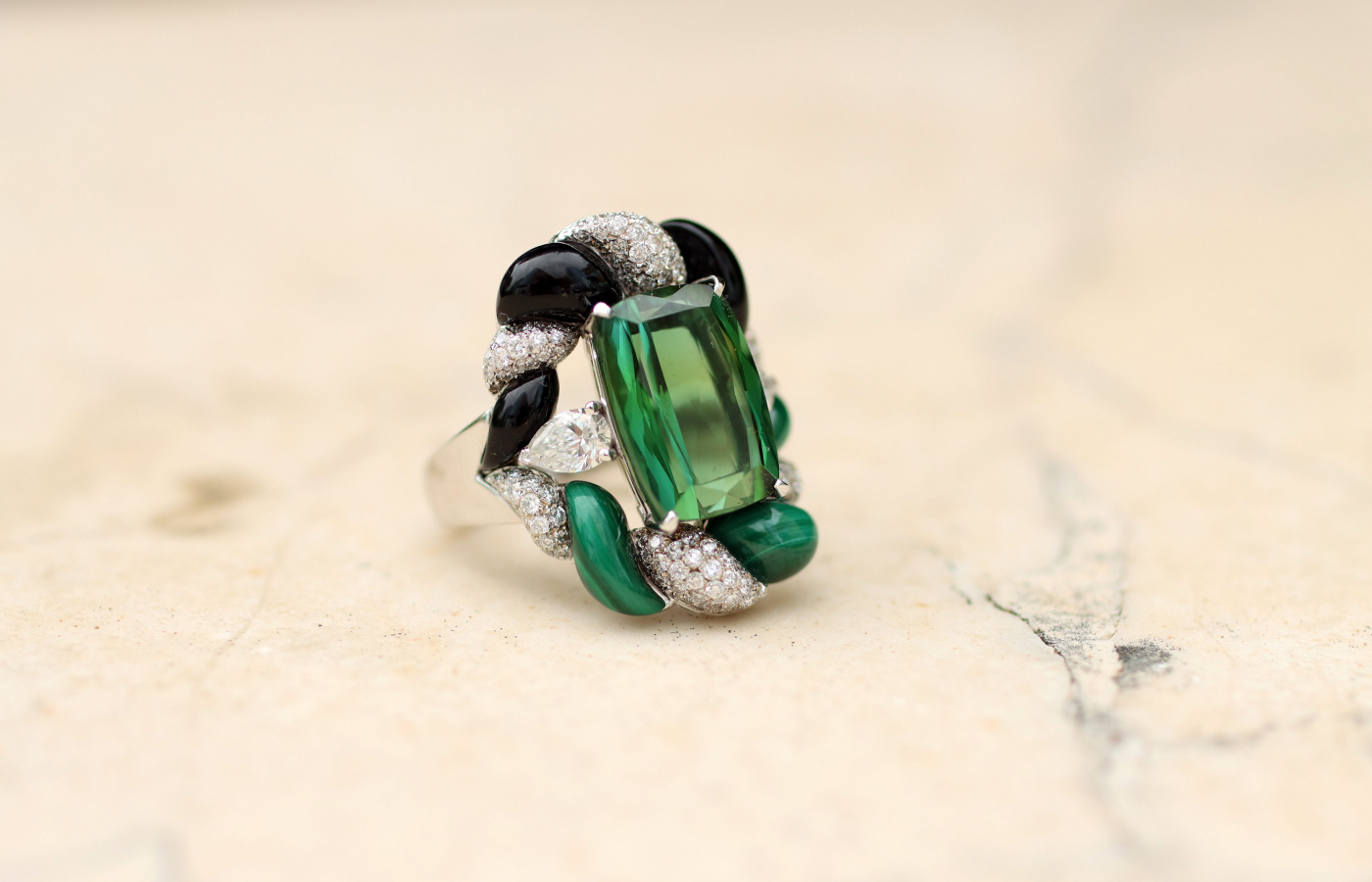  Maison J’OR Twist ring with a 7.3 carat green tourmaline, surrounded by 1.61 carats of diamonds, onyx and malachite in 18k white gold 