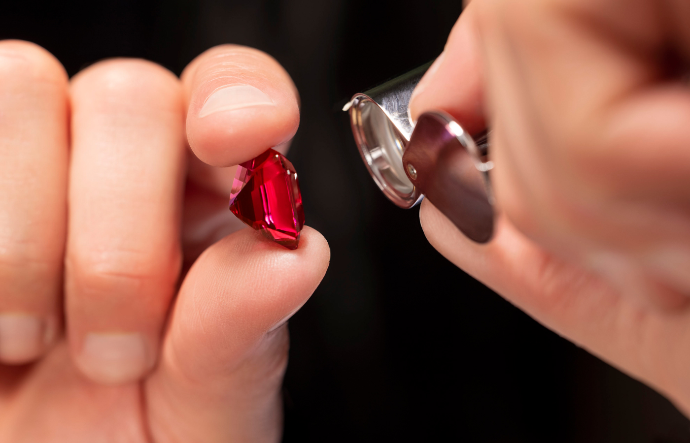  Bvlgari artisan inspecting a round-cut rubellite before setting onto the Earth Song necklace from the Aeterna collection
