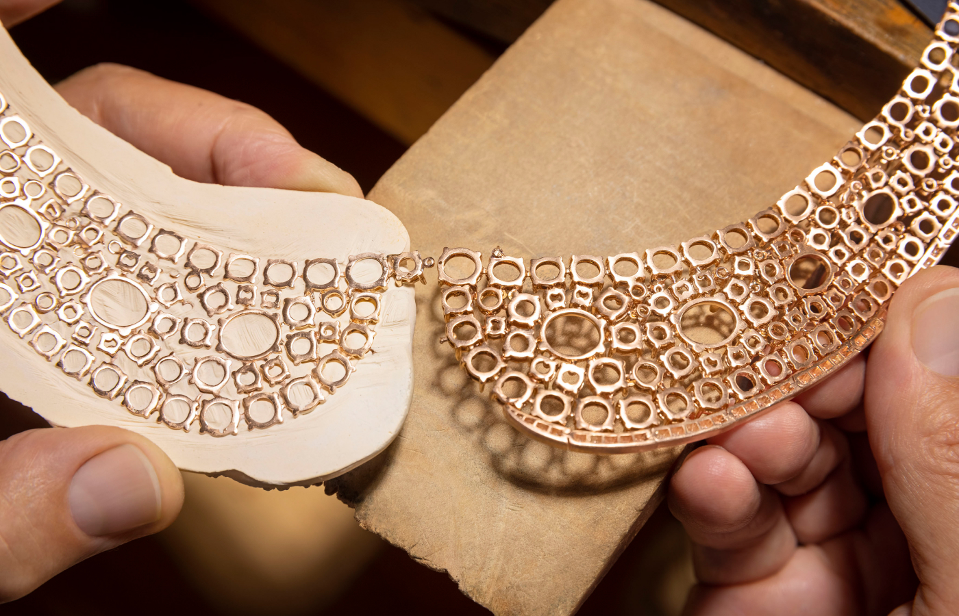  Bvlgari artisan holding the 18k yellow gold base from the Lotus Cabochon necklace from the Aeterna collection 