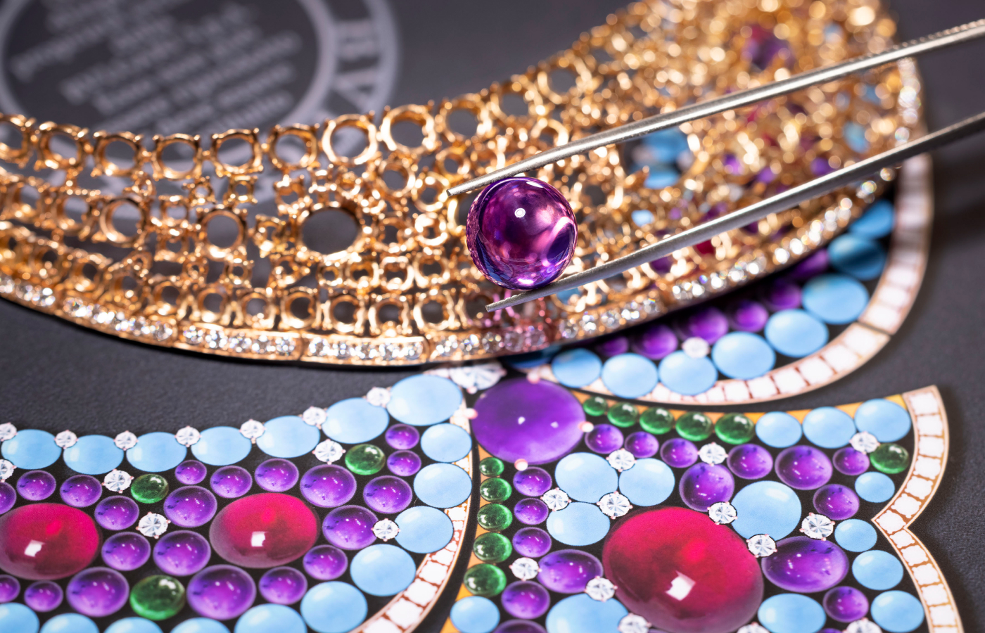  Bvlgari artisan setting the 18k yellow gold base of the Lotus Cabochon necklace from the Aeterna collection with  rubellite, turqoise, emerald and amethyst cabochons set on a 18kt gold base
