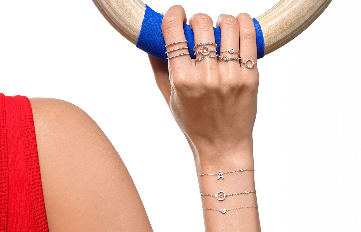  Model wearing an array of Djula's Magic Touch rings and bracelets with diamonds in 18k yellow, white and rose gold
