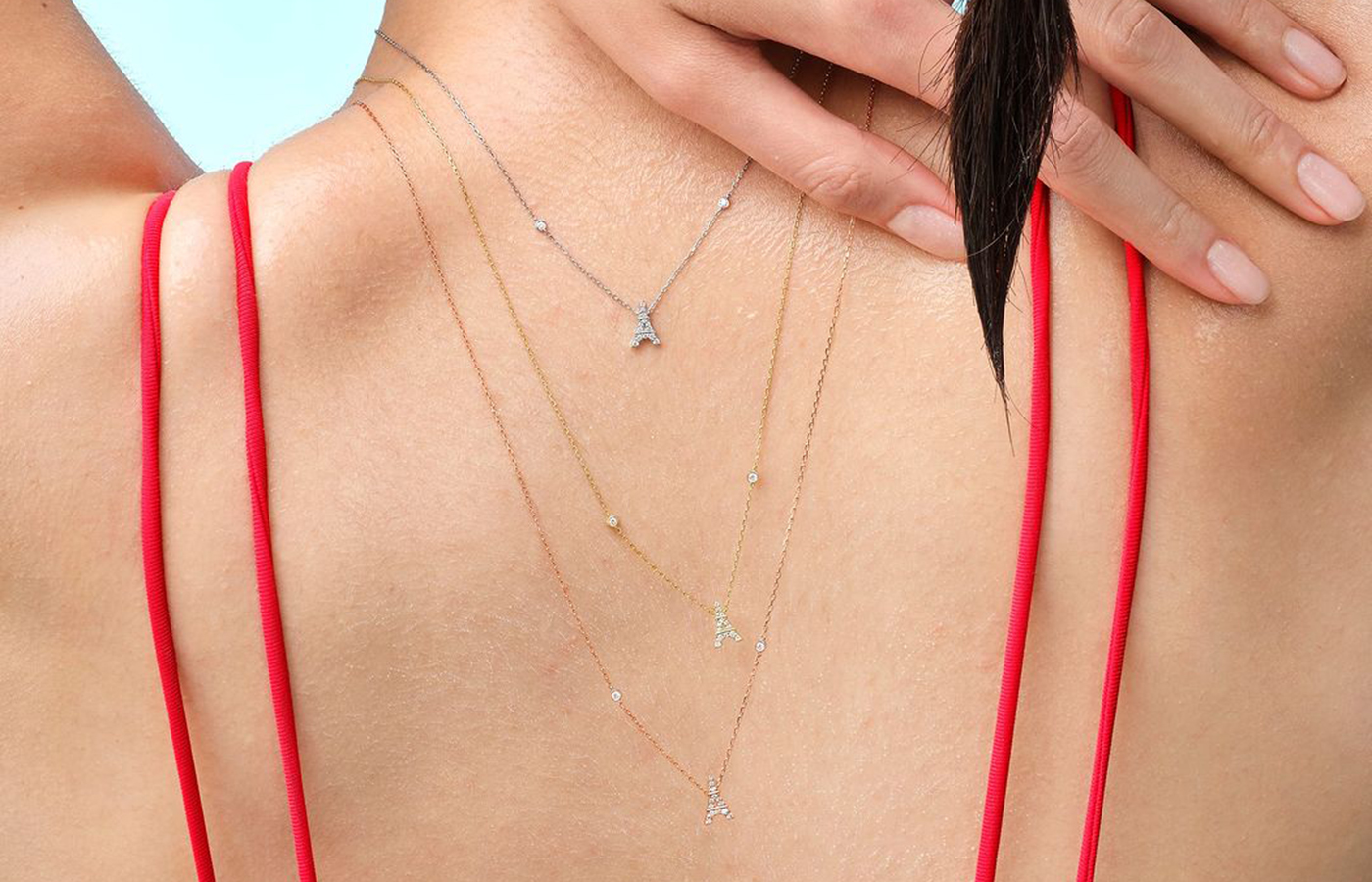  Model wears Djula's Magic Touch necklaces with diamonds in 18k yellow, white and rose gold