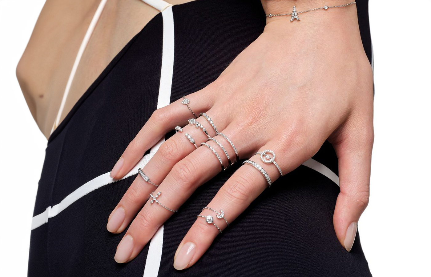  Model wearing an array of Djula's Magic Touch rings with diamonds in 18k white gold