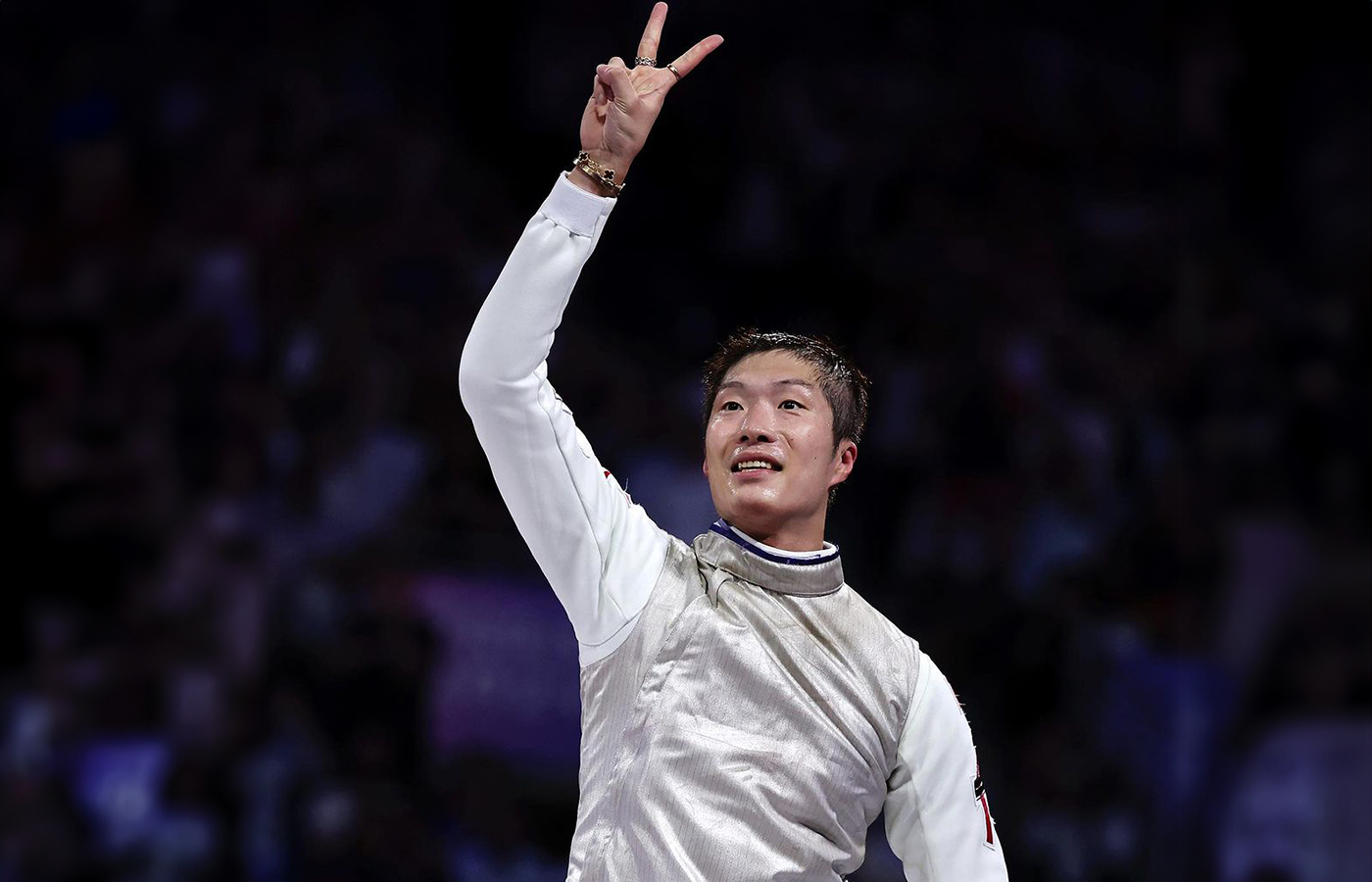  Gold medalist Cheung Ka Long at the Olympic Games Paris 2024 wearing a Van Cleef & Arpels Alhambra bracelet with carnelian in 18k yellow gold and a Cartier Love bangle with diamonds in 18k yellow gold
