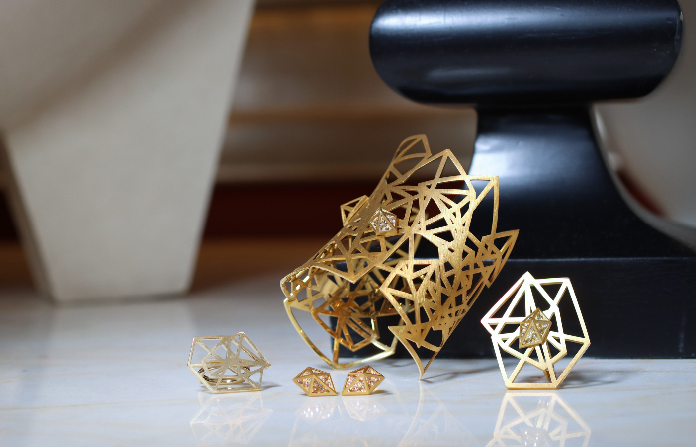 Jewellery designs from the Robert Guild Shattered collection, including a statement cuff bracelet crafted in brushed 18k yellow gold with 50 reverse-set round brilliant-cut diamonds totalling 1.20 carats 