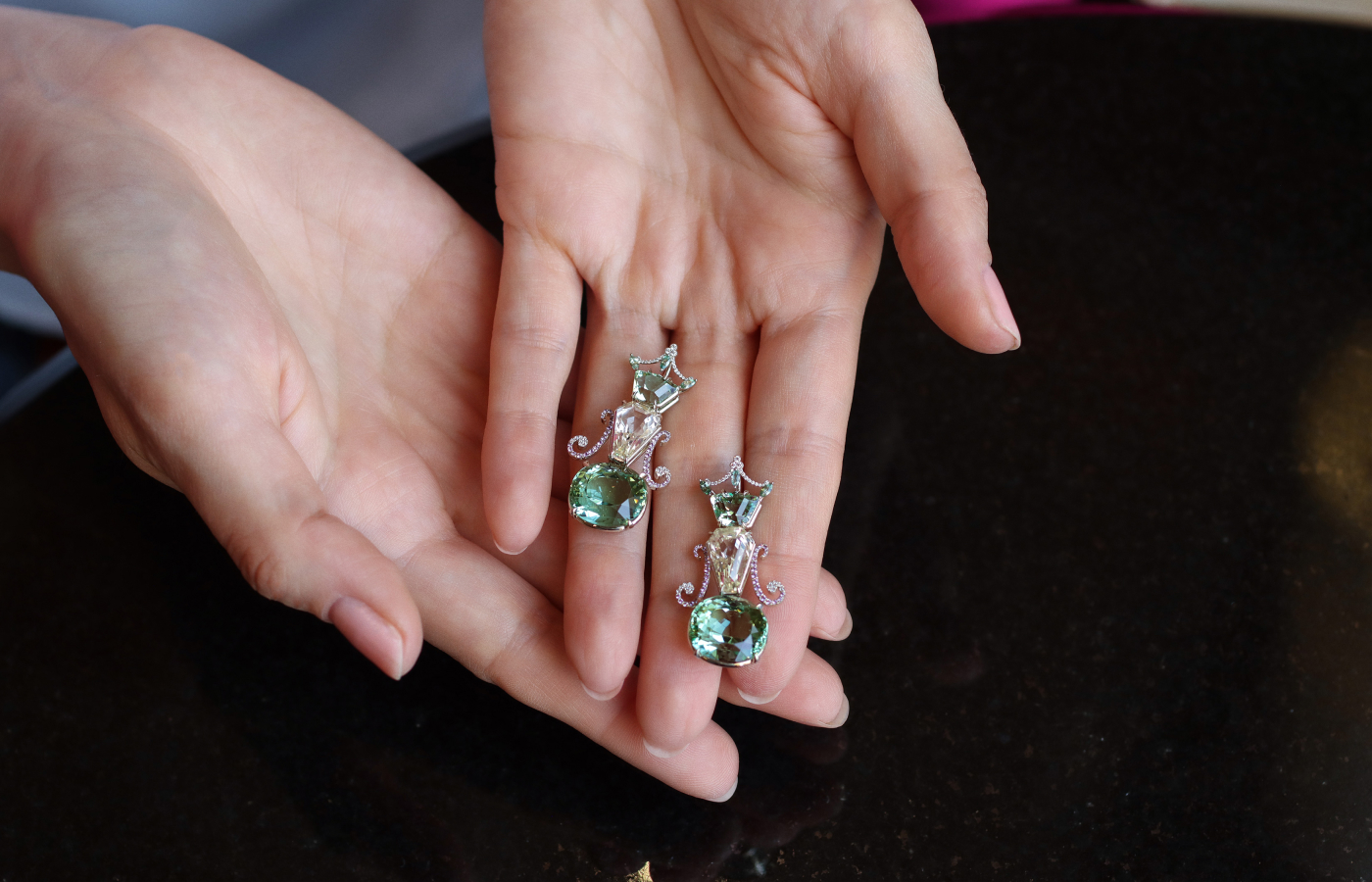 Robert Guild QE II earrings, which secured the AGTA Spectrum Award for ‘Best Use of Colour’ in 2022, set with a pair of rare kornerupines totalling 3.74 carats, 9.15 carats of yellow sapphires, and a pair of cushion-cut mint green tourmalines weighing 21.54 carats