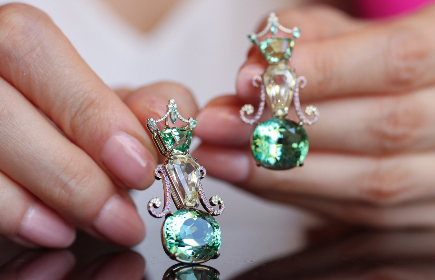  A closer look at the Robert Guild QE II earrings with a pair of rare kornerupines totalling 3.74 carats, 9.15 carats of yellow sapphires, and a pair of cushion-cut mint green tourmalines weighing 21.54 carats